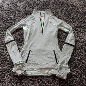 Beautiful mint green Lululemon zip up with black horizontal stripes.